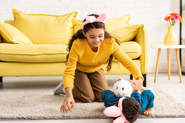 adorable kids in bunny ears having fun with white rabbit on floor - Photo, Image