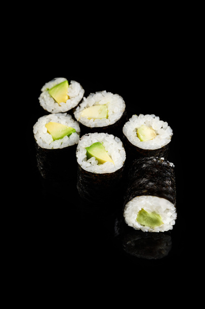 delicious sushi maki with avocado isolated on black - Foto, Imagem