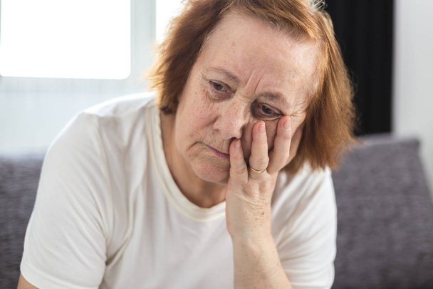 Portrait of depressed elderly woman having worries - Photo, Image