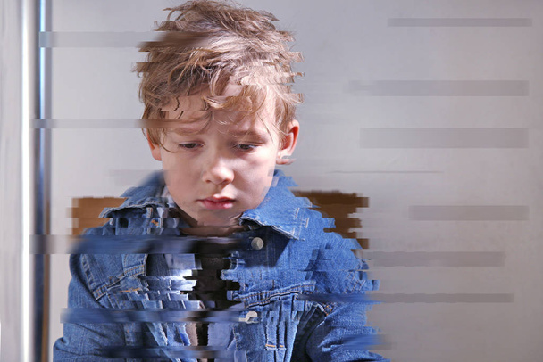 Portrait of depressed little boy indoors - Photo, Image
