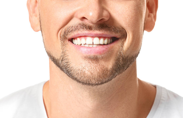 Handsome man with healthy teeth on white background, closeup - Photo, Image