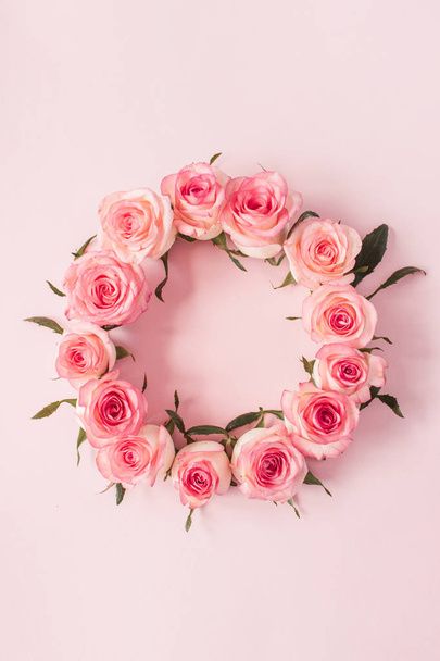 Marco redondo borde de rosa rosa brotes de flores sobre fondo rosa. Espacio de copia en blanco de burla. Puesta plana, vista superior composición floral
. - Foto, Imagen