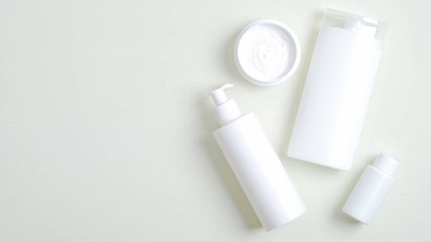 Cosmetics SPA branding mockup. Clear minimalist beauty products packaging, shampoo bottle, lotion container, essential oil, cream jar. Top view, flat lay - Photo, image