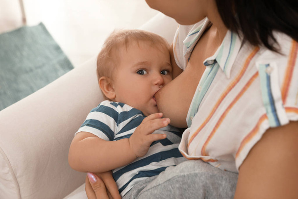 Woman breastfeeding her little baby at home, closeup - Zdjęcie, obraz