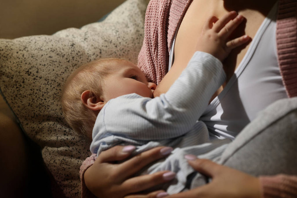 Woman breastfeeding her little baby at home, closeup - Fotoğraf, Görsel