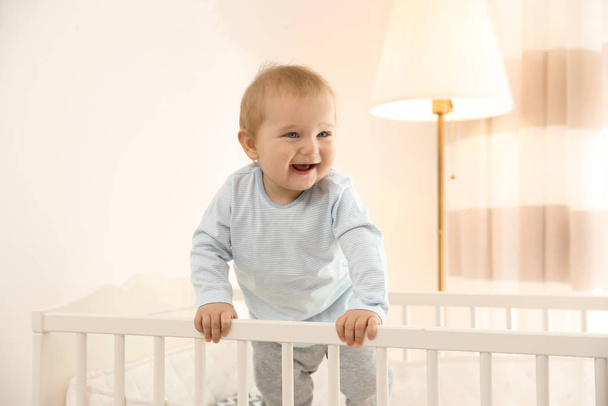 Cute little baby in crib at home - Valokuva, kuva