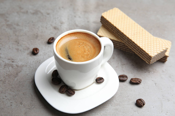 Delicious coffee and wafers for breakfast on grey table - Φωτογραφία, εικόνα