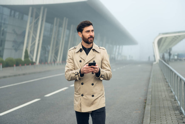 Businessman texting messages while walking. - Fotó, kép