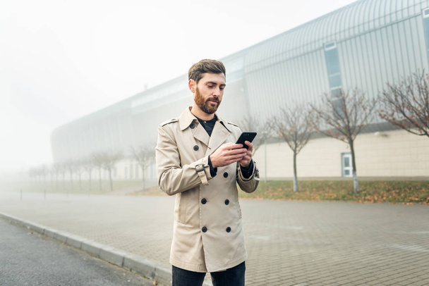 Businessman texting messages while walking. - Foto, Imagem