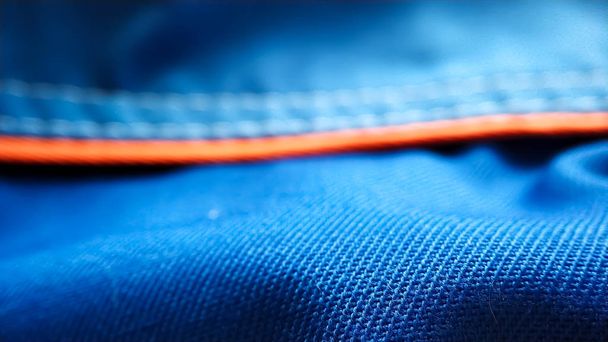 Μπλε εργασίας ομοιόμορφη ρούχα με μια πορτοκαλί λωρίδα μακροεντολή - Φωτογραφία, εικόνα