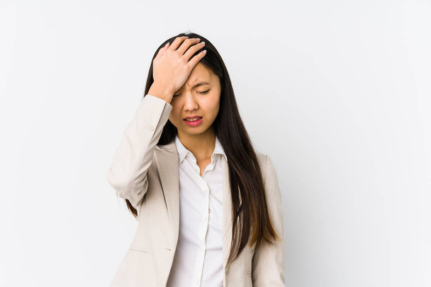 Young chinese business woman isolated forgetting something, slapping forehead with palm and closing eyes. - Photo, image