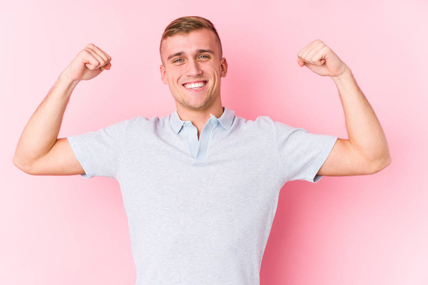 Young caucasian man isolated showing strength gesture with arms, symbol of feminine power - Photo, Image