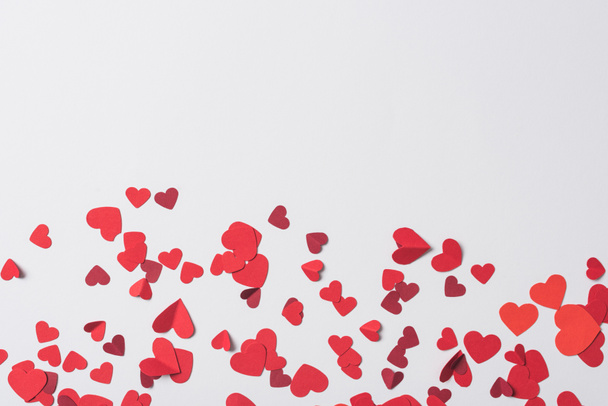 top view of red hearts scattered on white background - Fotó, kép