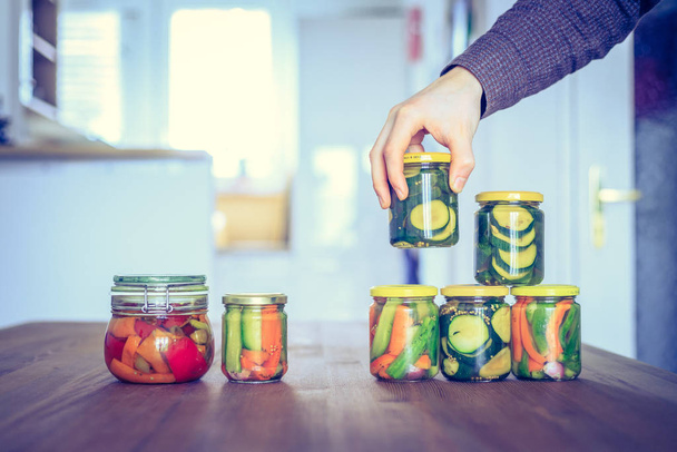 Preserving and conserving a variety of vegetables in glasses  - 写真・画像