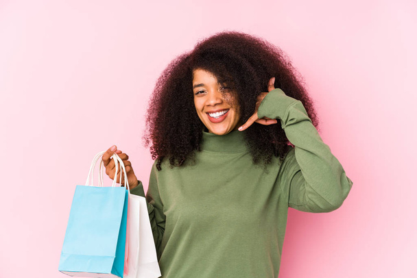 junge Afro-Frau einkaufen isoliert junge Afro-Frau kaufen isolajunge Afro-Frau hält eine Rose isoliert haben eine Idee, Inspiration Konzept - Foto, Bild