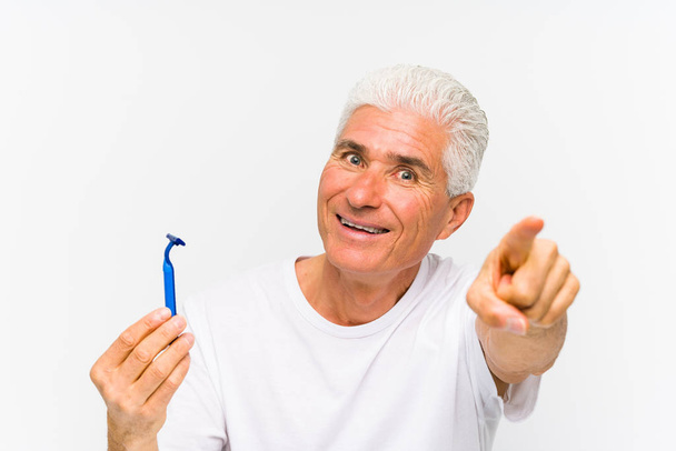 Senior caucasian man holding a razor blade  - Fotó, kép