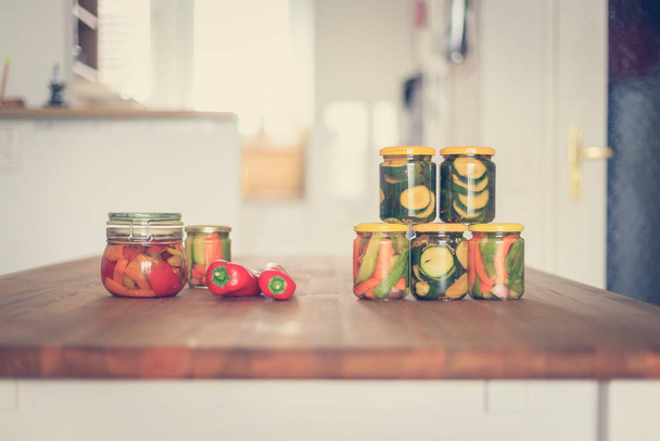 Preserving and conserving a variety of vegetables in glasses  - 写真・画像