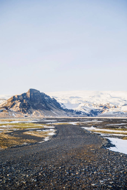 beautiful view of Iceland mountains with snowy tops and black roads - Fotoğraf, Görsel