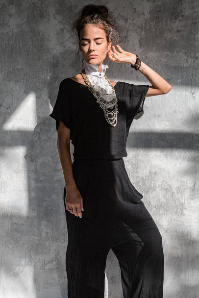 young fashion woman in black dress posing on simple background - Фото, зображення