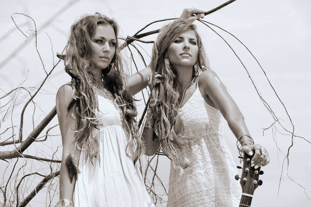 Two beautiful bohemian style women posing outdoors - Fotografie, Obrázek