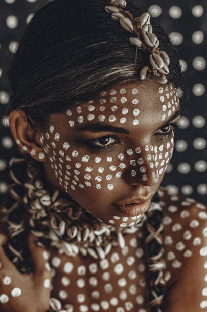 closeup portrait of beautiful young female model painted with dots on skin - Fotoğraf, Görsel