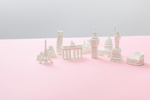 souvenirs from different countries on grey and pink  - Photo, Image