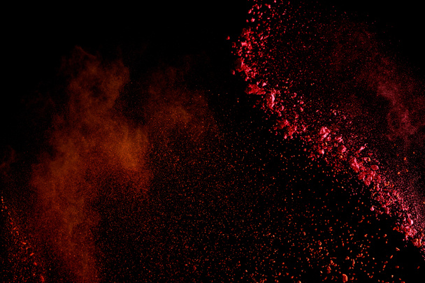 赤いカラフルなホリは黒い背景に爆発をペイント - 写真・画像