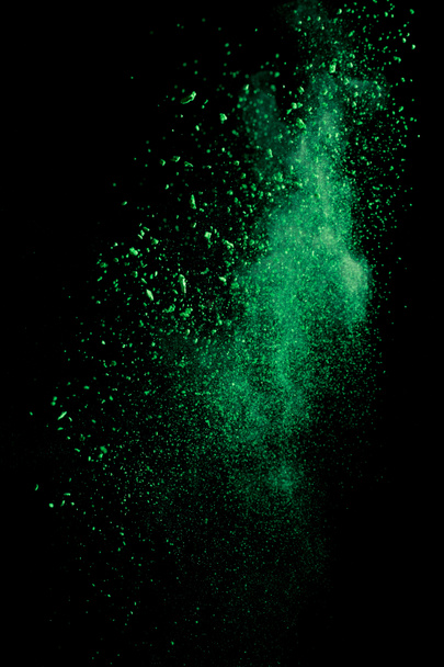 green colorful holi paint explosion on black background - 写真・画像