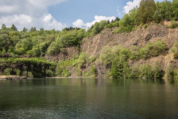 Mountain slope made of basalt rock on the lake - Photo, Image