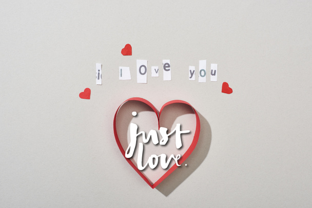 Top view of paper hearts with i love you lettering and just love illustration on grey background - Fotografie, Obrázek
