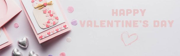 top view of valentines decoration, greeting card, hearts, confetti on white background with happy valentines day illustration, panoramic shot - Photo, Image
