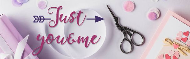top view of valentines gifts, ribbon and scissors on white background with just you and me lettering, panoramic shot - Photo, image