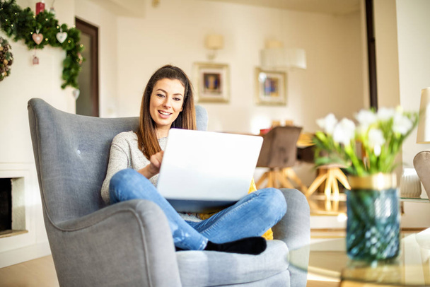 Casual businesswoman using laptop while working online from home - Foto, immagini
