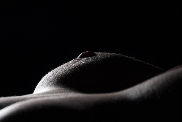 naked woman with black breast on a dark background - Zdjęcie, obraz