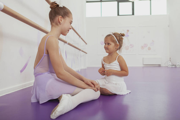 Charming two young ballerinas practicing at ballet class - Photo, image
