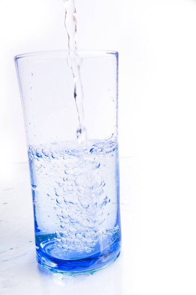 water splash in glass isolated on white - Foto, imagen