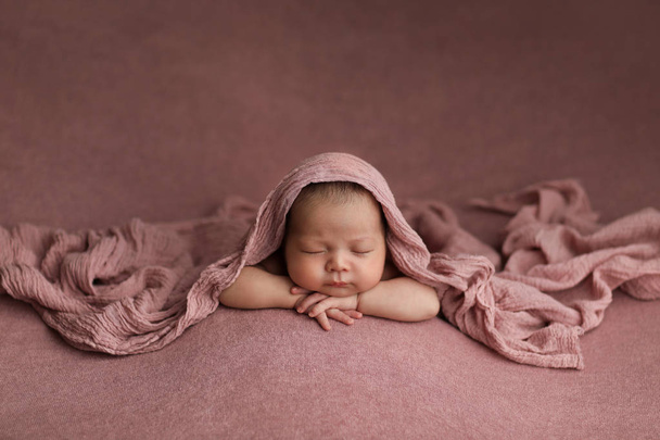 Asian girl in Arabic style on a pink background.  sleeping beautiful newborn baby. - Photo, Image