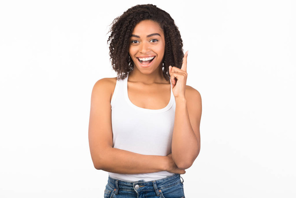 Excited black girl having great idea pointing up - Photo, image