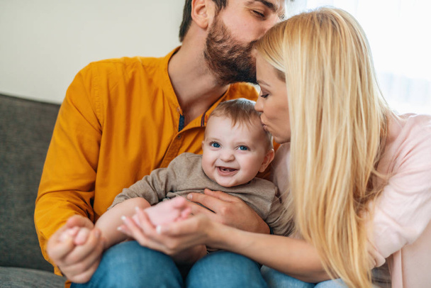 Happy mother and father with baby at home - Photo, Image