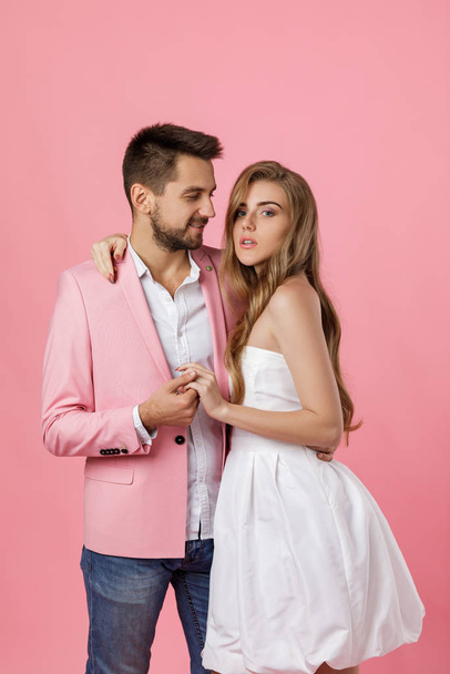 happy couple in love embracing on pink background. st valentines day - 写真・画像