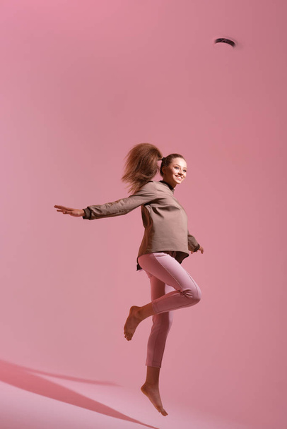 studio shot of young woman jumping  - Fotó, kép