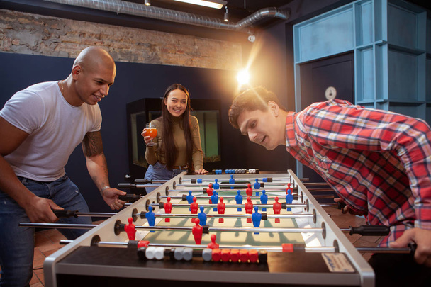 Group of friends playing table soccer at beer pub - Fotografie, Obrázek