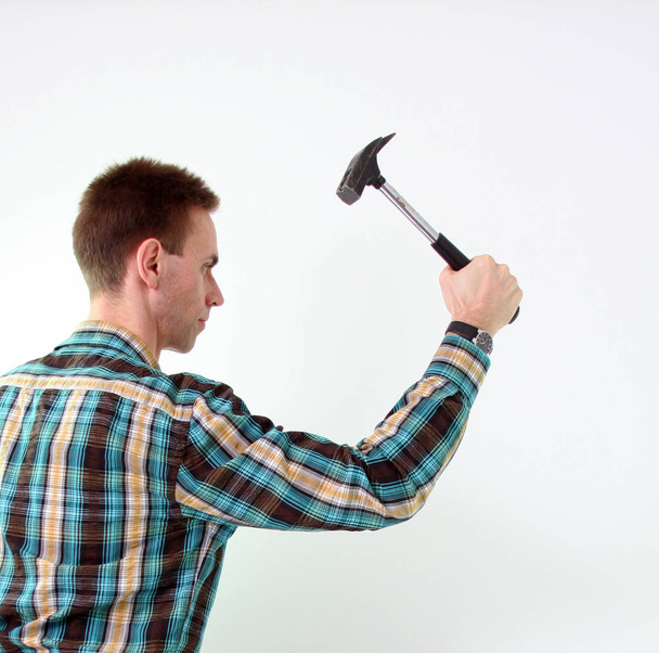man with hammer in hands on white background - Valokuva, kuva
