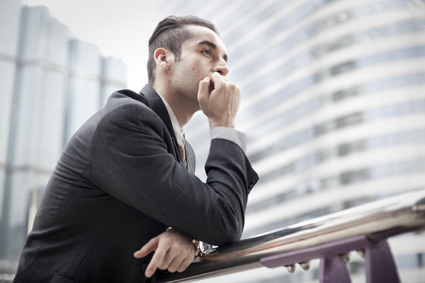 Portrait of a businessman thinking - Фото, изображение