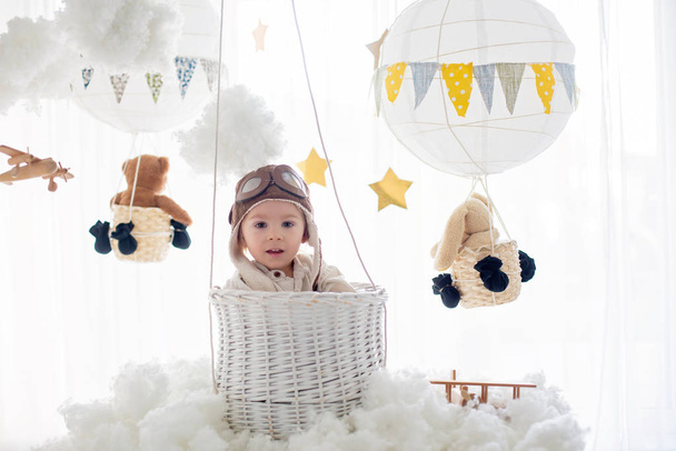 Sweet toddler boy, playing with airplane and teddy bear, air bal - Фото, зображення