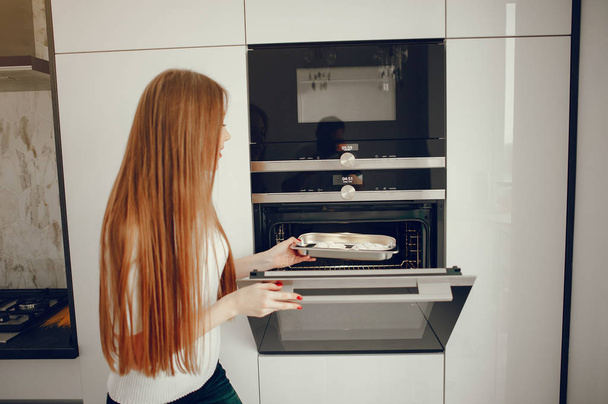 Beautiful woman prepare food in a kitchen - Foto, imagen