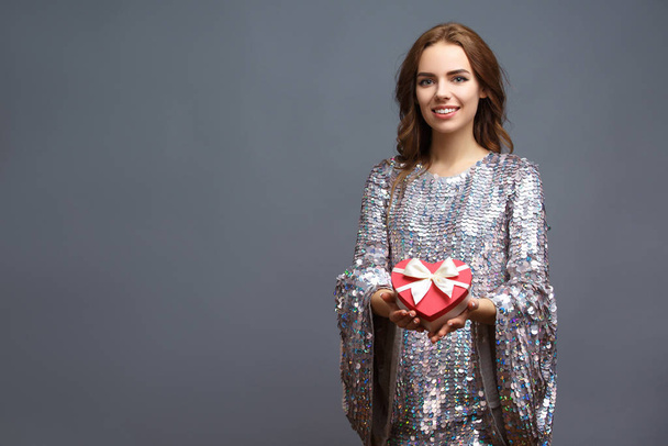 girl in shiny dress with gift box - Foto, Imagen