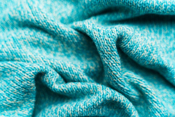 Crumpled texture of a blue turquoise knitted fabric - Foto, Imagem