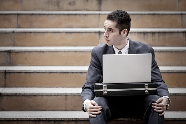 Handsome businessman using laptop - Фото, изображение