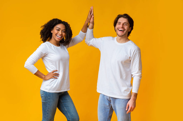Joyful Afro Girl And White Guy Giving Figh-Five To Each Other - Photo, Image